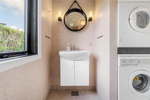 a bathroom with a sink and a washing machine at LF14102-Roslev-Eskovvej-102 in Roslev