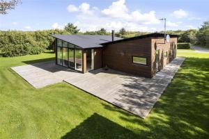 a small house with a deck in the grass at LF530-Vestervig-Hannesvej-30 in Vestervig
