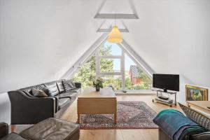 a living room with a couch and a tv at 0007-Romo-Juvrevej-37 in Høm