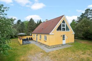 a yellow house with a red roof on a yard at 0007-Romo-Juvrevej-37 in Høm