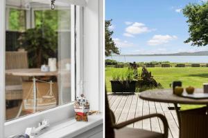 a window of a house with a view of the ocean at LF15319-Hojslev-Jelsevej-319 in Højslev