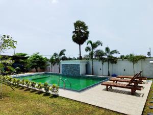 a swimming pool with a picnic table and a bench at Panorama Safari Villa in Trincomalee