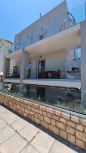 a large building with a stone wall at Diamante Del Mar Crete Rhodes in Kos