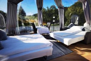 two beds in a room with a table and chairs at Banpim Aroradome and jacusszy in Gravdal