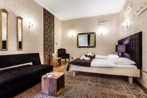 Ένα ή περισσότερα κρεβάτια σε δωμάτιο στο Aparthotel Oberża