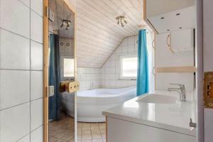a bathroom with a tub and a toilet and a sink at 0142-Romo-Ivigtut-1 in Høm +20 photos