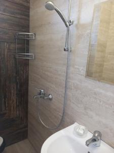 a bathroom with a shower and a sink at Вила Дъбрава in Sinemorets +65 photos