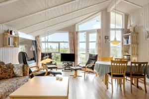 a living room with a couch and a table and chairs at LF694-Hurup-Thy-Haettemagevej-8 in Sindrup
