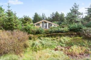 a house on top of a hill with trees at LF694-Hurup-Thy-Haettemagevej-8 in Sindrup
