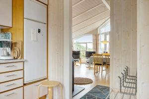 a kitchen and dining room with a table and chairs at LF694-Hurup-Thy-Haettemagevej-8 in Sindrup