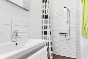 a white bathroom with a sink and a shower at LF338-Vestervig-Gunhildsvej-38 in Vestervig +13 photos