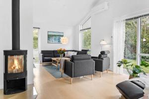 a living room with a fireplace and couches at LF338-Vestervig-Gunhildsvej-38 in Vestervig