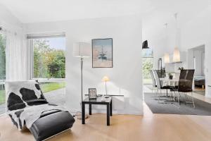 a white living room with a chair and a table at LF338-Vestervig-Gunhildsvej-38 in Vestervig