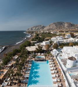 an aerial view of a resort with a swimming pool and the beach at Nikki Beach Resort & Spa Santorini in Kamari