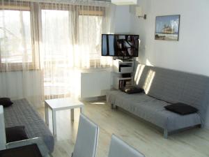 a living room with a couch and a flat screen tv at Zdrojowa 26 Apartament 35 in Świnoujście