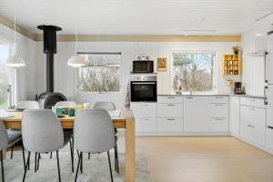a kitchen and dining room with a table and chairs at LF11101-Struer-Blabaervej-12 in Struer