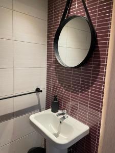 a bathroom with a sink and a mirror at Olea Luxury Living in Nea Fokea +14 photos