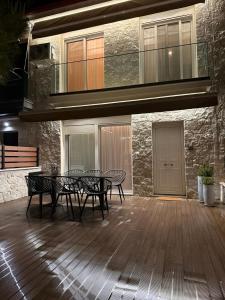 a patio with two chairs and a table in front of a building at Olea Luxury Living in Nea Fokea