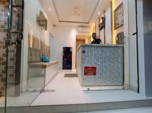a man is standing behind a gate in a building at Hotel Shree krishna in Ujjain