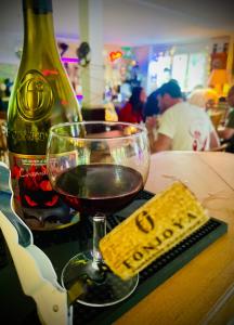 a glass of wine and a bottle of alcohol on a table at Rockin 70's Lodges in Barbey-Séroux