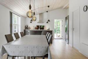 a kitchen and dining room with a table and chairs at LF143-Vestervig-Gunhildsvej-43 in Vestervig
