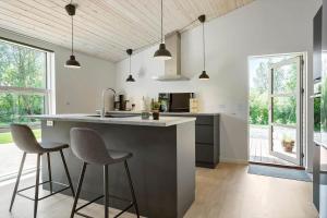 a kitchen with a large island with two bar stools at LF143-Vestervig-Gunhildsvej-43 in Vestervig +15 photos