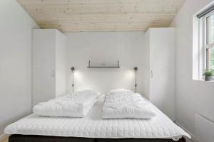 a bed in a white room with two pillows at LF143-Vestervig-Gunhildsvej-43 in Vestervig