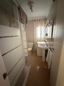 a bathroom with a toilet and a sink at Casa Emilia in Talayuelas +13 photos