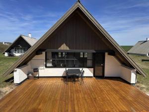 a house with a wooden deck with a bench on it at 531-Lemvig-Lokkevej-59-C in Lemvig +21 photos