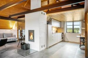 a living room with a fireplace in the middle at 531-Lemvig-Lokkevej-59-C in Lemvig