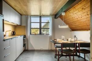 a kitchen with a table and chairs in a room at 531-Lemvig-Lokkevej-59-C in Lemvig
