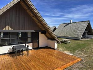 a house with a wooden deck in front of it at 531-Lemvig-Lokkevej-59-C in Lemvig