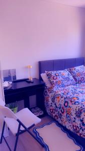 a bedroom with a bed and a desk and a chair at 32 Hatton Guest House in Milton Keynes