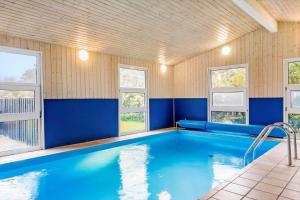 a swimming pool in a house with blue walls and windows at LF159-Vestervig-Gunhildsvej-39 in Vestervig