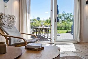 a living room with a door open to a patio at LF159-Vestervig-Gunhildsvej-39 in Vestervig