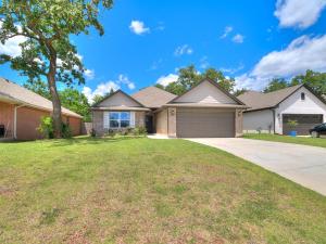 a large house with a tree and a driveway at Your Unforgettable Temporary Haven! in Edmond