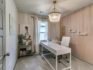 a office with a white desk and a chandelier at Your Unforgettable Temporary Haven! in Edmond
