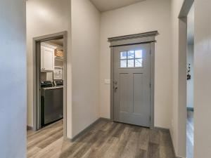 an empty room with a door and a kitchen at Your Unforgettable Temporary Haven! in Edmond