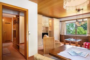 a living room with a table and a dining room at Ferienhaus Isele in Feldberg