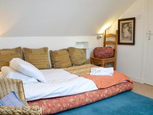 a large bed with pillows on it in a room at Ruach in Gardenstown +6 photos
