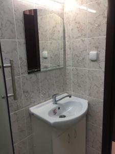 a bathroom with a sink and a mirror at Hotel Prestige in Astrakhan