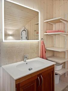 a bathroom with a sink and a mirror at 0143-Romo-Ejnar-Mikkelsensvej-11 in Høm +16 photos