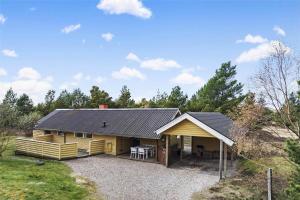 a large yellow house with a black roof at 0143-Romo-Ejnar-Mikkelsensvej-11 in Høm