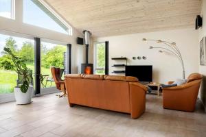 a living room with a couch and a table at LF14344-Roslev-Folvigvej-44 in Roslev