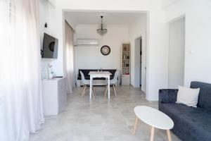 a living room with a blue couch and a table at Rodostagma 2 in Rodholívos
