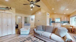 a living room with a couch and a ceiling fan at American Eagle Retreat in Conover