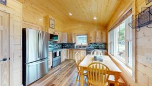a kitchen with a table and a refrigerator at American Eagle Retreat in Conover