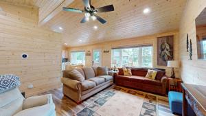 a living room with a couch and a ceiling fan at American Eagle Retreat in Conover