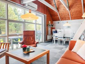 a living room with orange chairs and a table at 0273-Romo-Lyngvejen-63-B in Høm