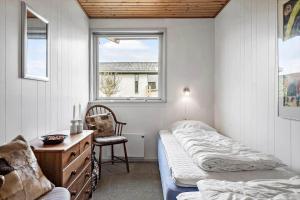 a bedroom with a bed and a desk and a window at LF880-Snedsted-Over-Reese-11 in Snedsted